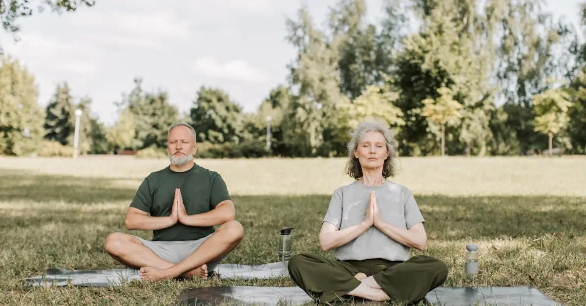 Senior couple meditating on yoga mats in a serene park setting, enjoying peaceful yoga practice.